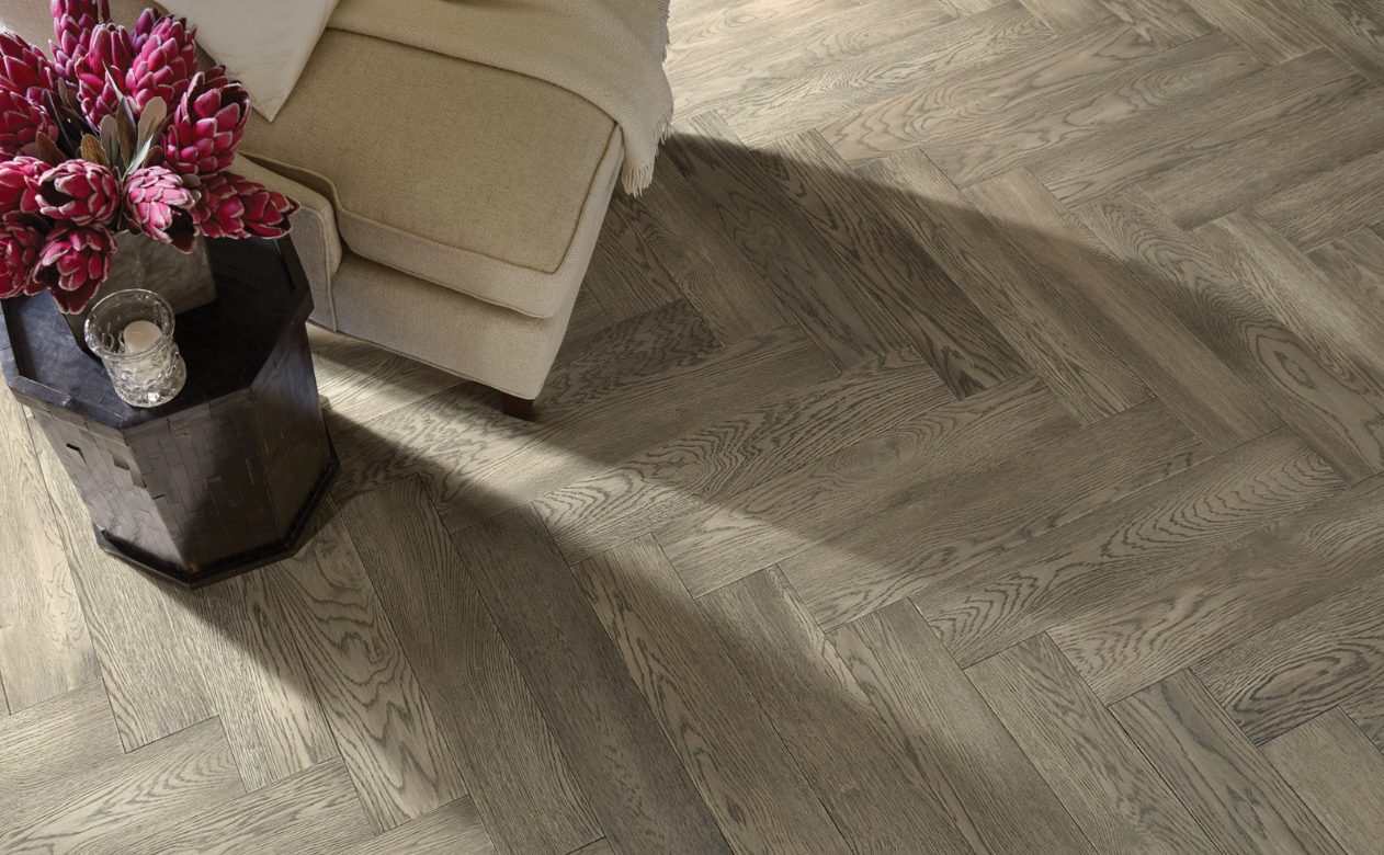 Herringbone hardwood floor with chair and tulip bouquet 