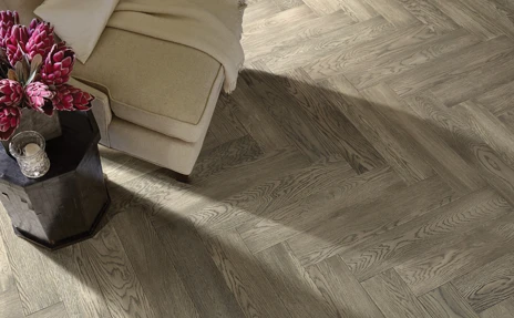 Herringbone hardwood floor with chair and tulip bouquet 