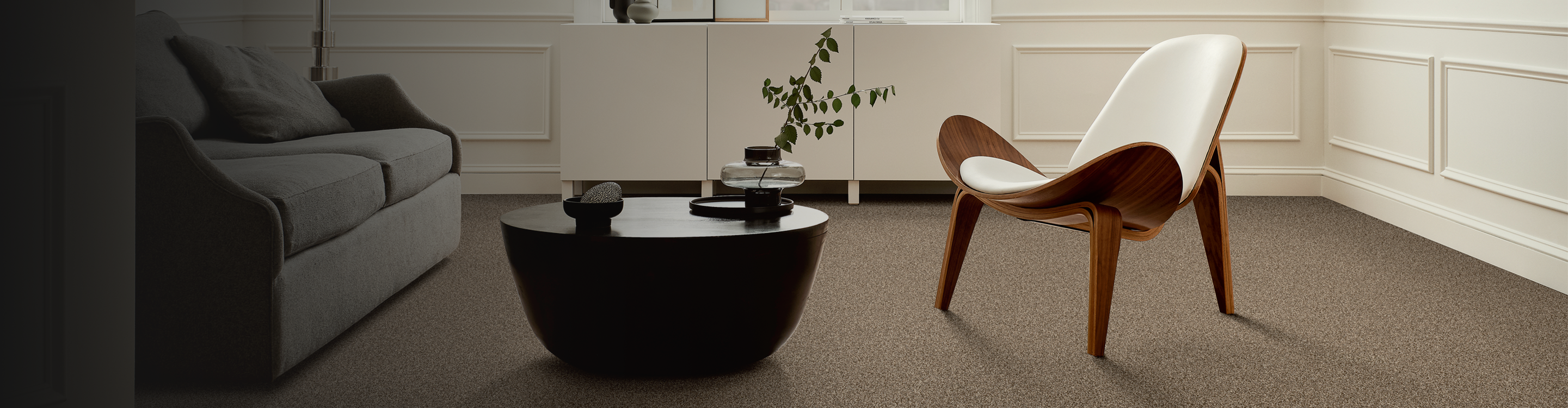 brown carpet in a seating area with wood accent chair